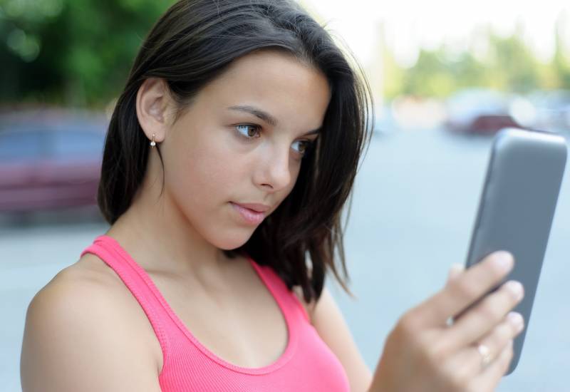 Girl using tablet PC outdoor